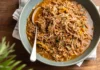Pernil seasoned with pepper and paprika, cooked in a pressure cooker.